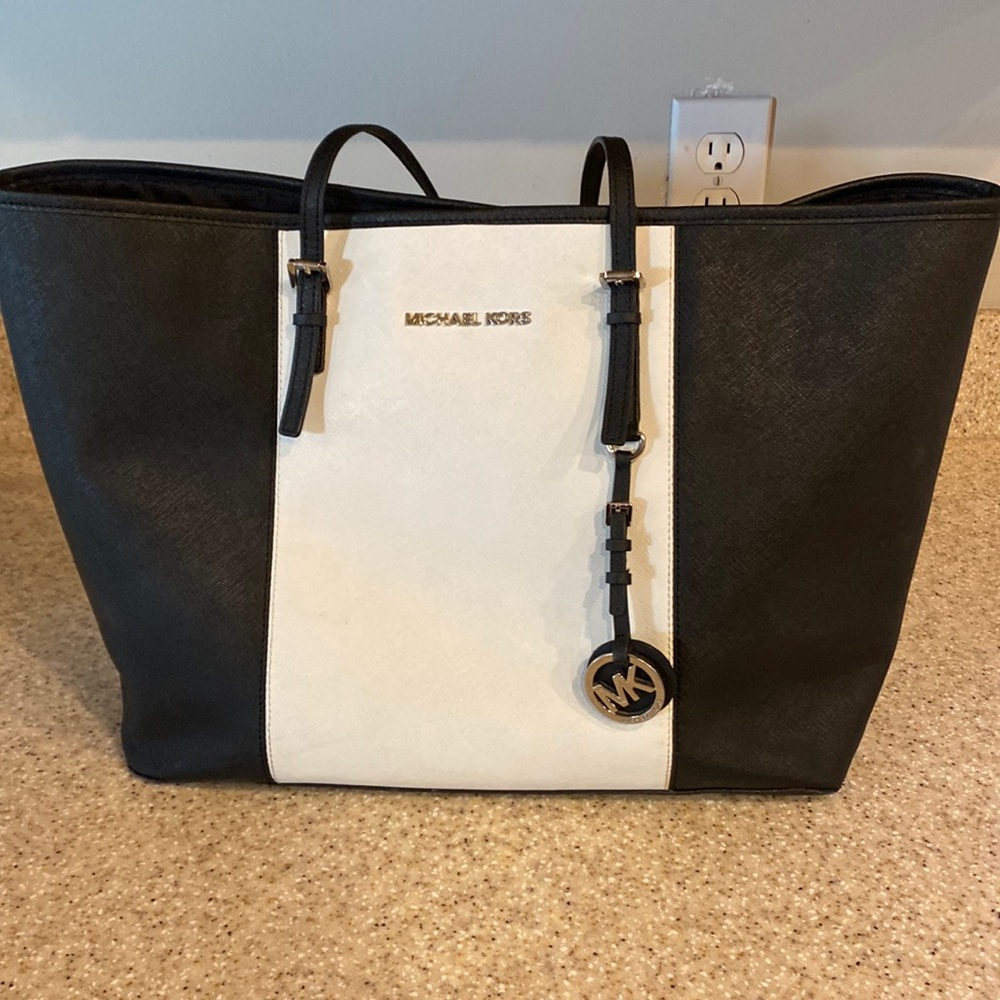 Michael Kors black and white tote/purse. Some wear on the straps (pictured)